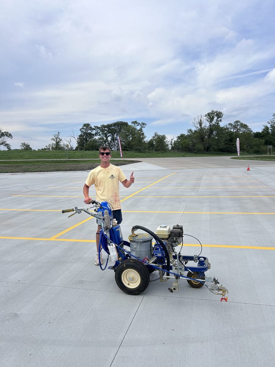 Karter with the line striper on fresh concrete